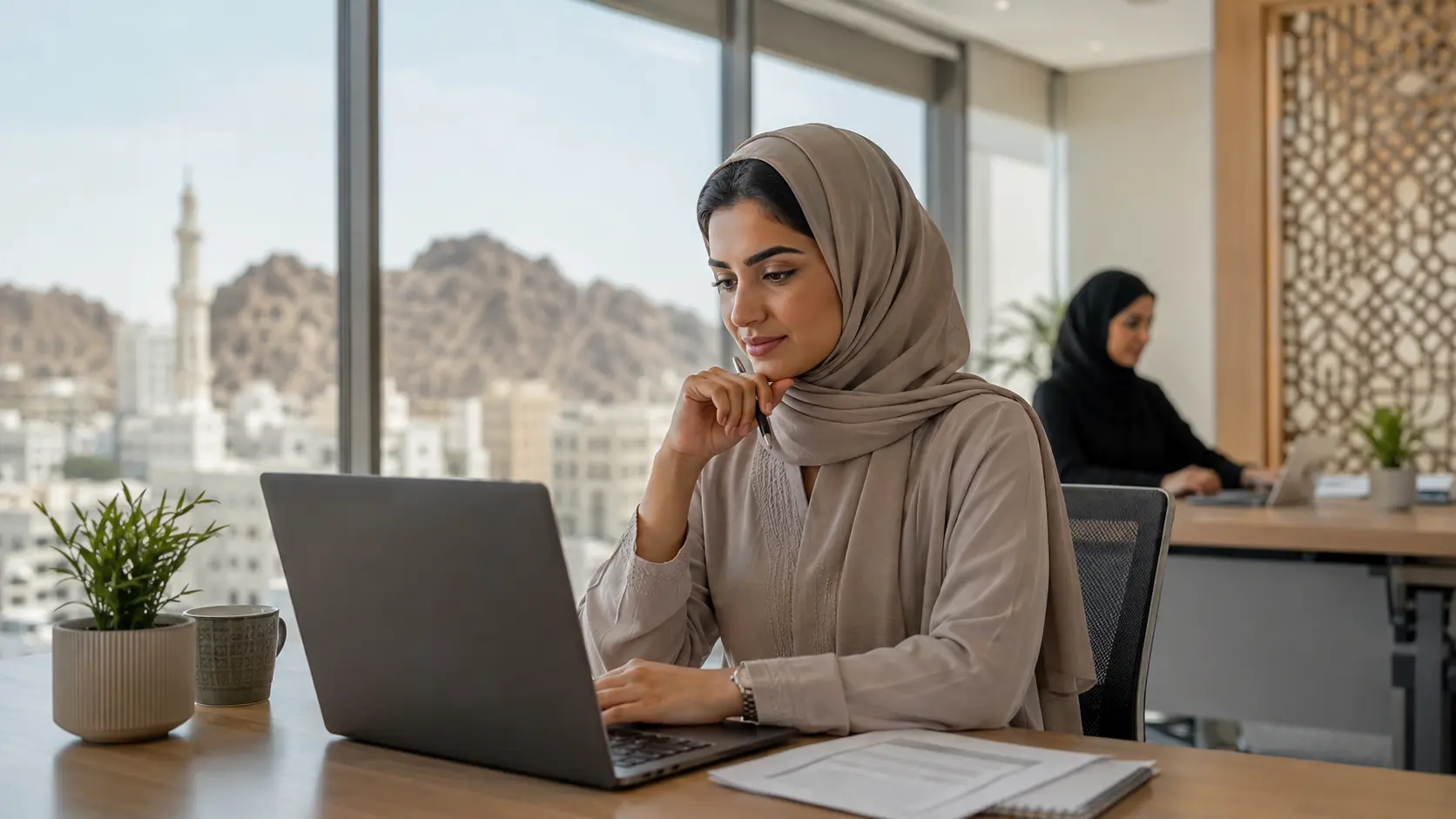 A professional preparing a CV in a Muscat office