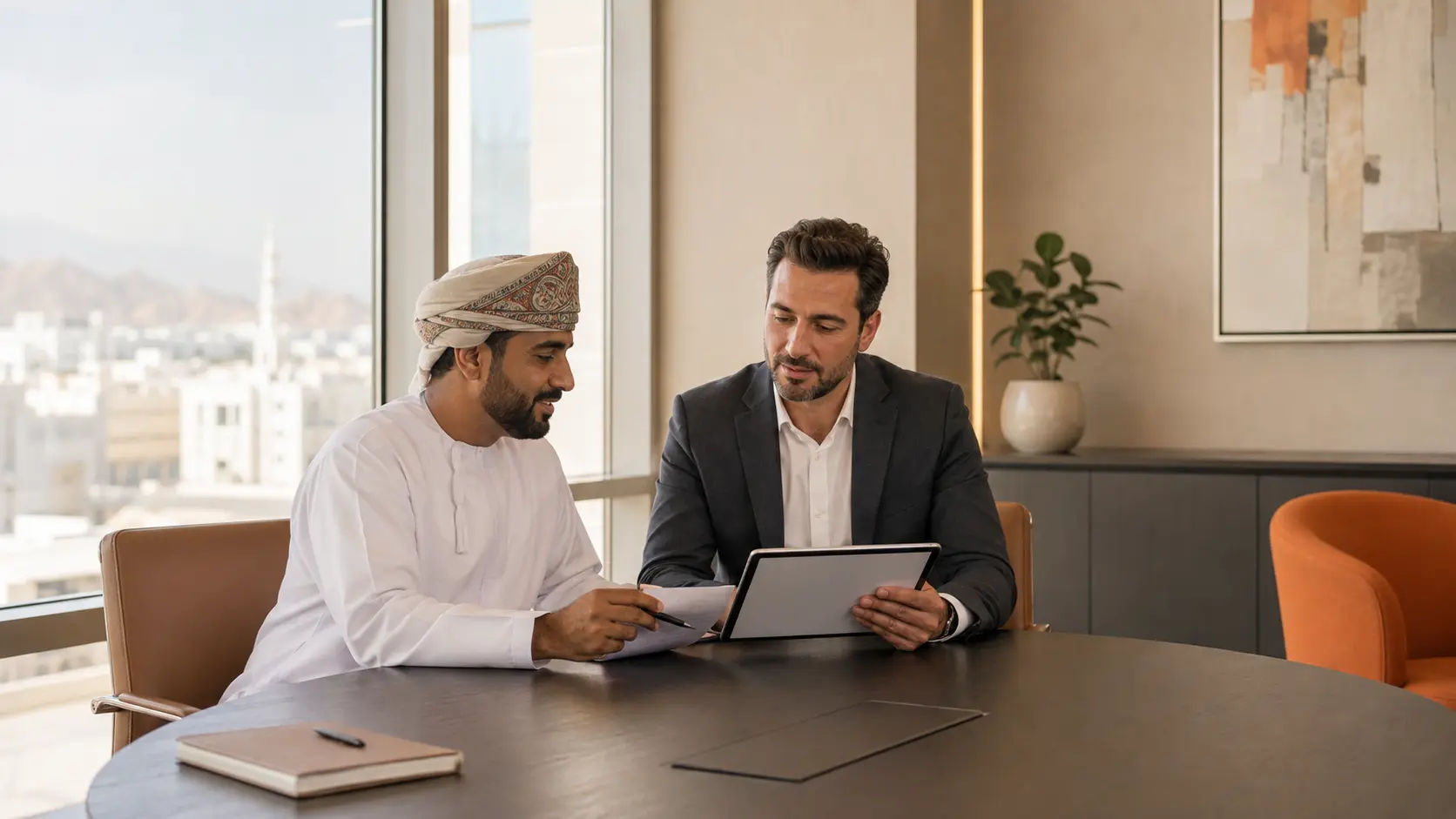 An Omani employer and staffing adviser reviewing a workforce plan